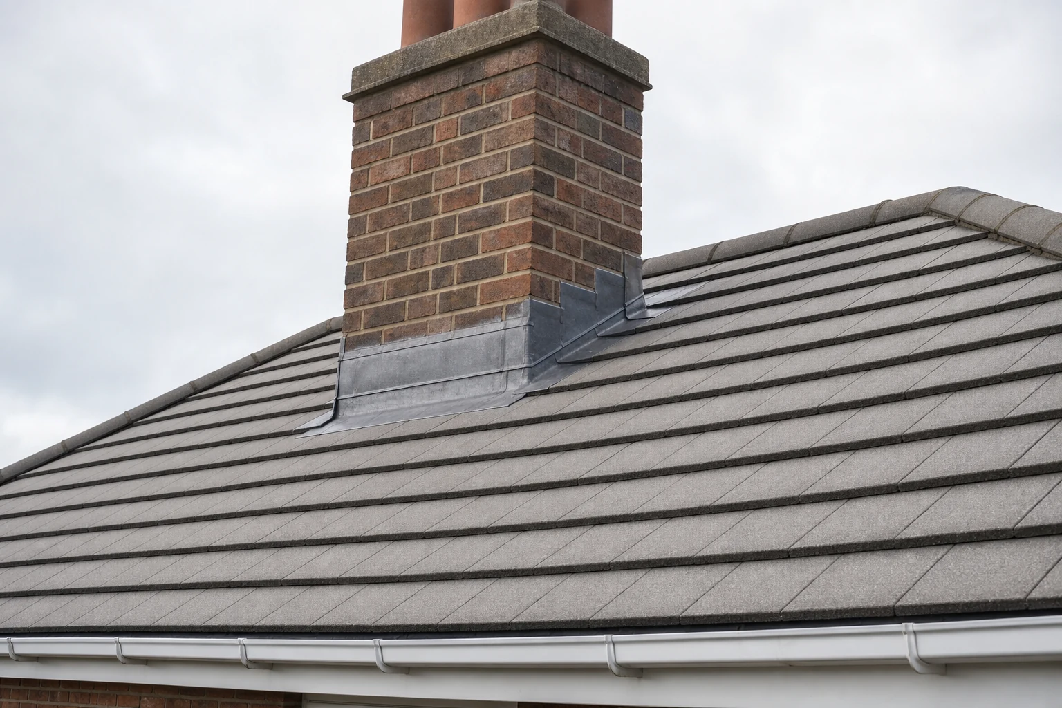 Neat repaired chimney flashing on a tiled roof